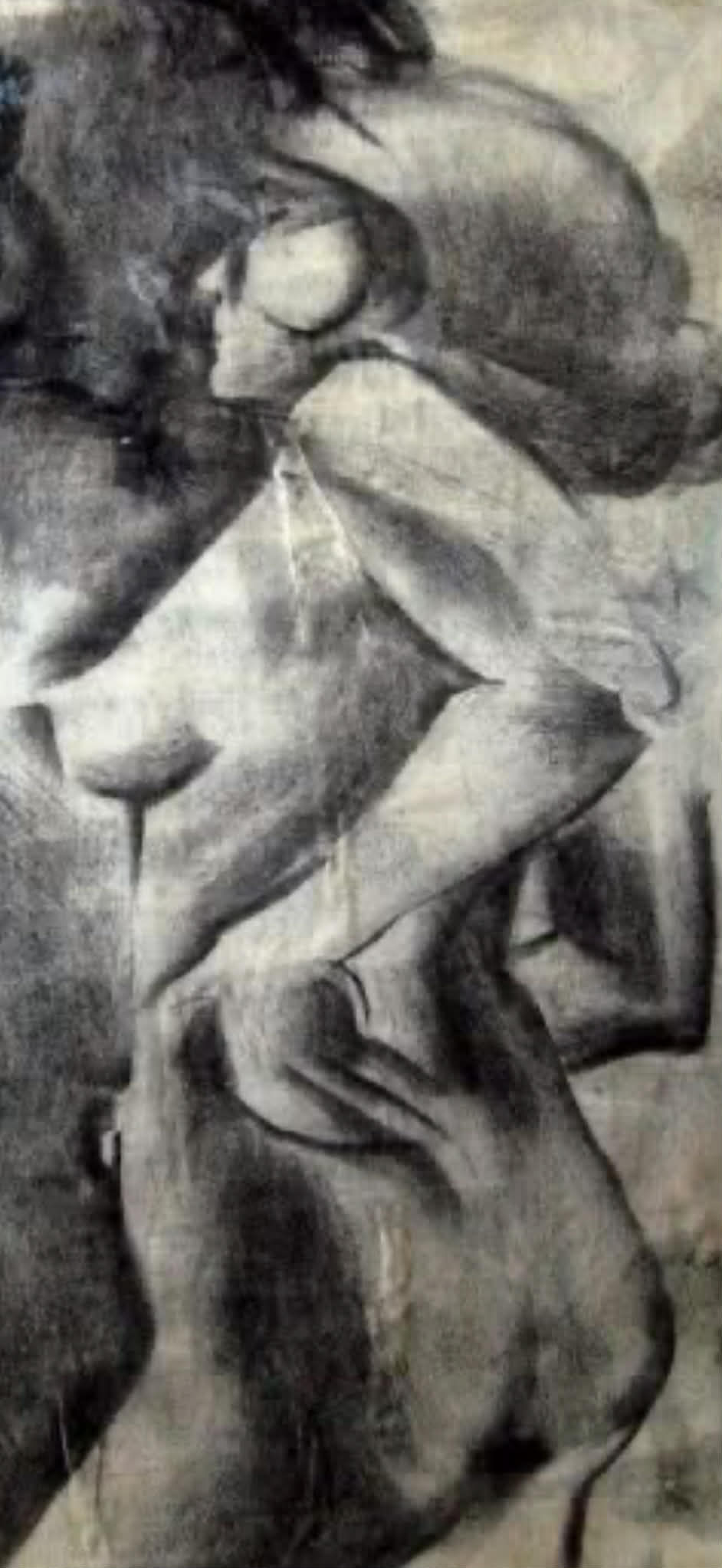 Eye-level view of an artist sketching a seated model in a studio setting