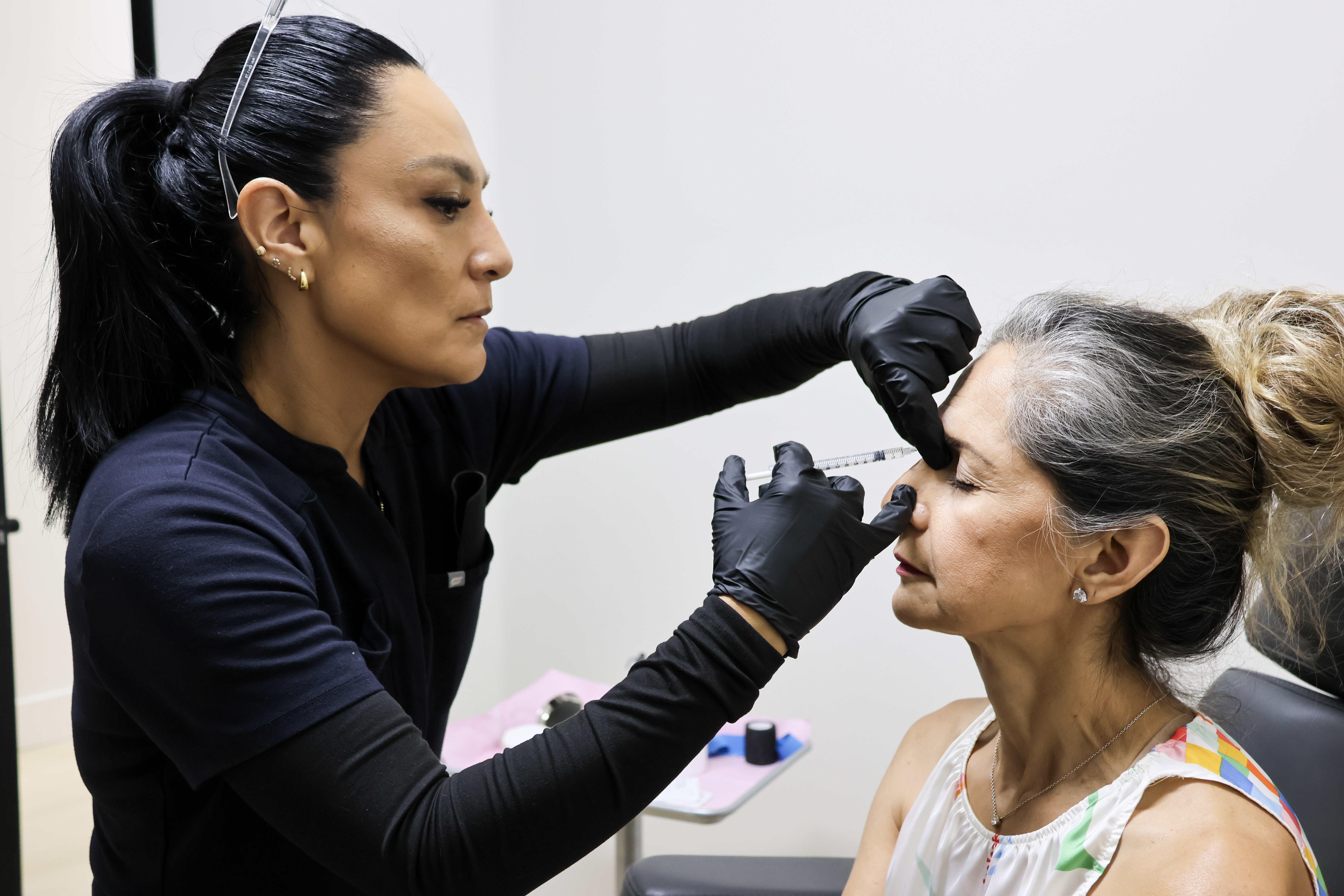 Provider administering a facial aesthetic treatment
