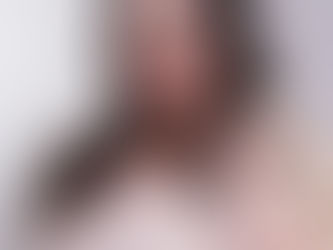 a professional woman smiling with a coat in hand