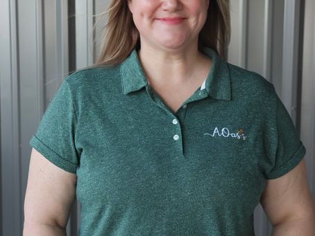 Photo of smiling woman in work polo