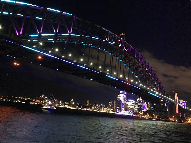 Sydney Harbour Bridge lit  up in colour at night for the light festival