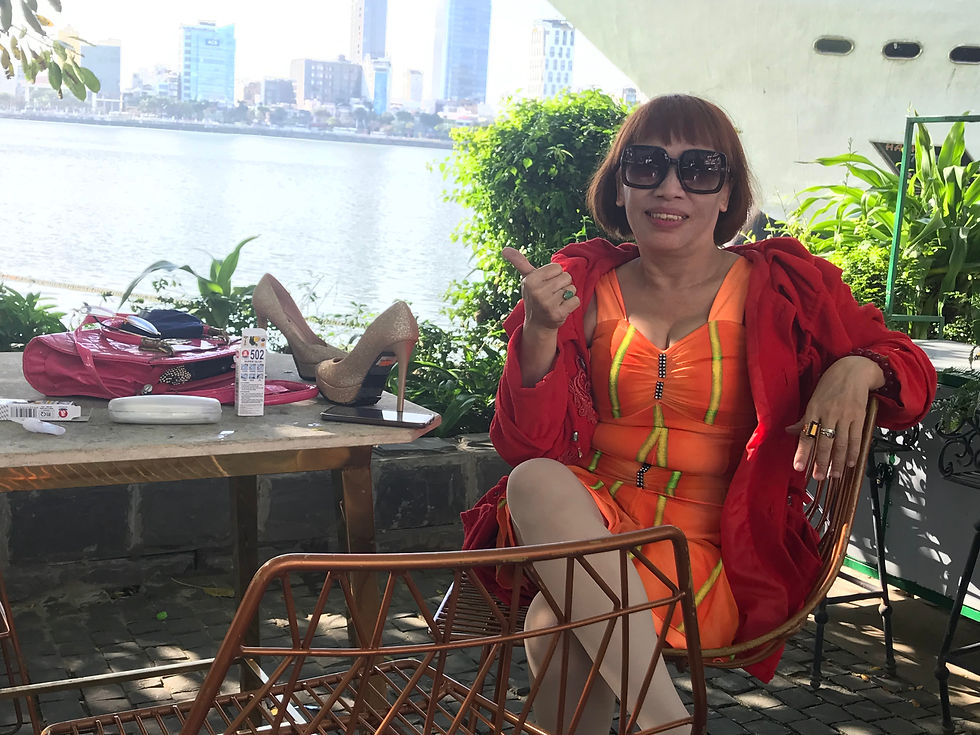 Woman in Vibrant orange dress by the river
