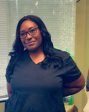 Ziquia in Bright Braces office smiling with glasses