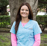 Bright Braces Office Manager Shannon Kelly smiles in blue scrubs in Katy.
