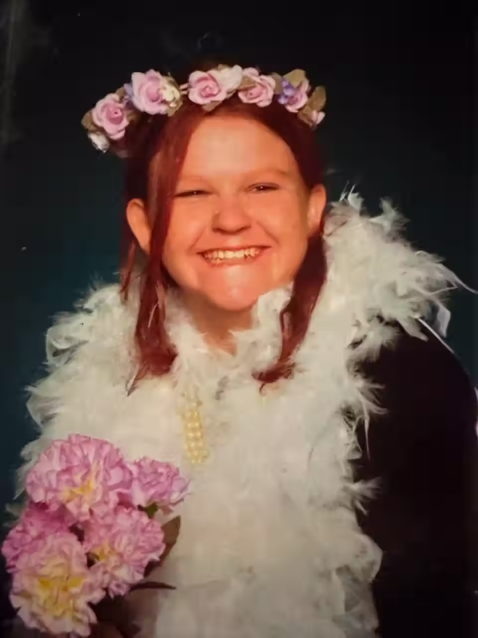 Jessica Gaudie smiling in a feather boa.