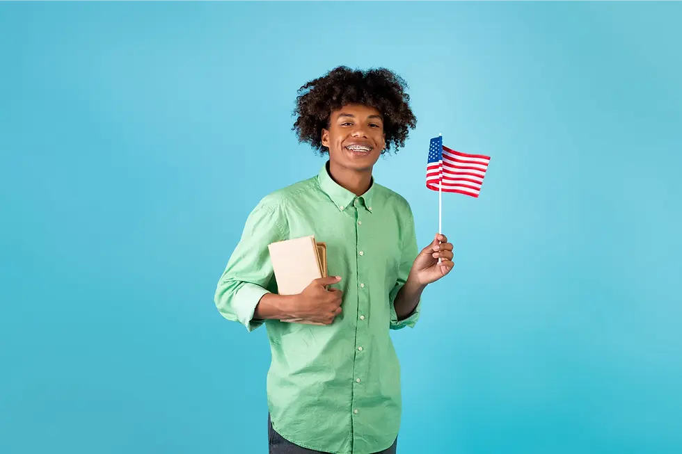 Teen with braces smiling and holding an American flag.