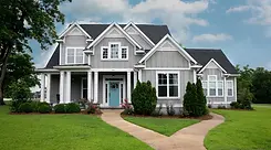 Two-story home with white double hung replacement windows throughout the exterior