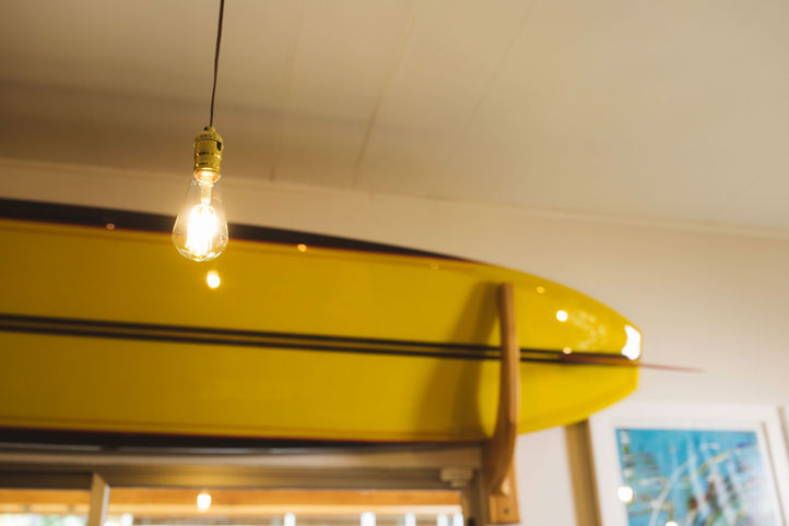 longboard on display on the wall at Olo Alaia surf shop