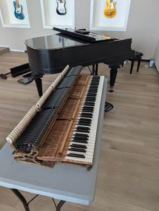 A grand piano with its action pulled out