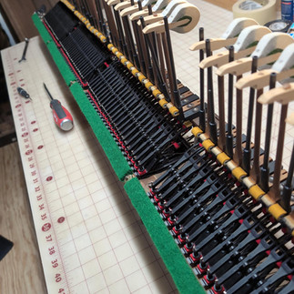 A grand piano action with some replaced parts