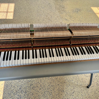 Grand piano action on a folding table