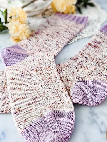 the Meringue Socks knit in speckled yarn and dyed by Lay Family Yarn