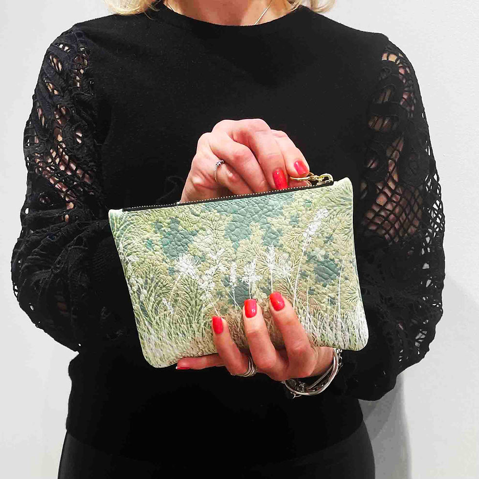 Thumbnail: Napa leather clutch bag, small with meadow pattern worn by a model