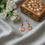 Thumbnail: Solid rose gold pendant earrings with continental fittings, lifestyle image