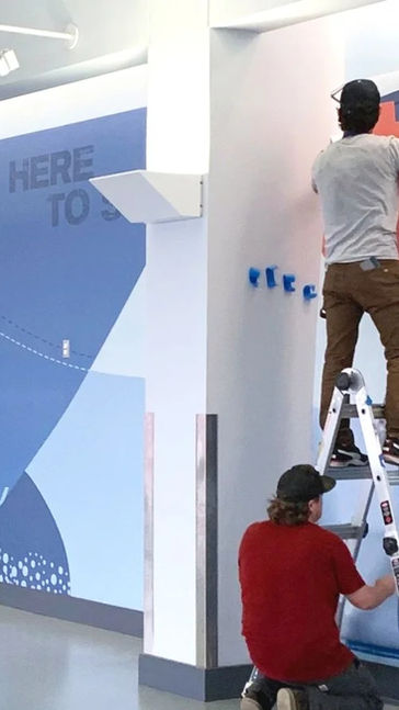 Large vertical wall graphics installed onsite