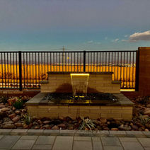Backyard water feature at dusk with soft ambient lighting