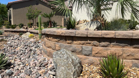 2-foot curved retainer wall planter and river rock for a desert water smart landscape.