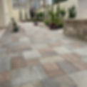 multi-colored paver walkway with a custom water feature