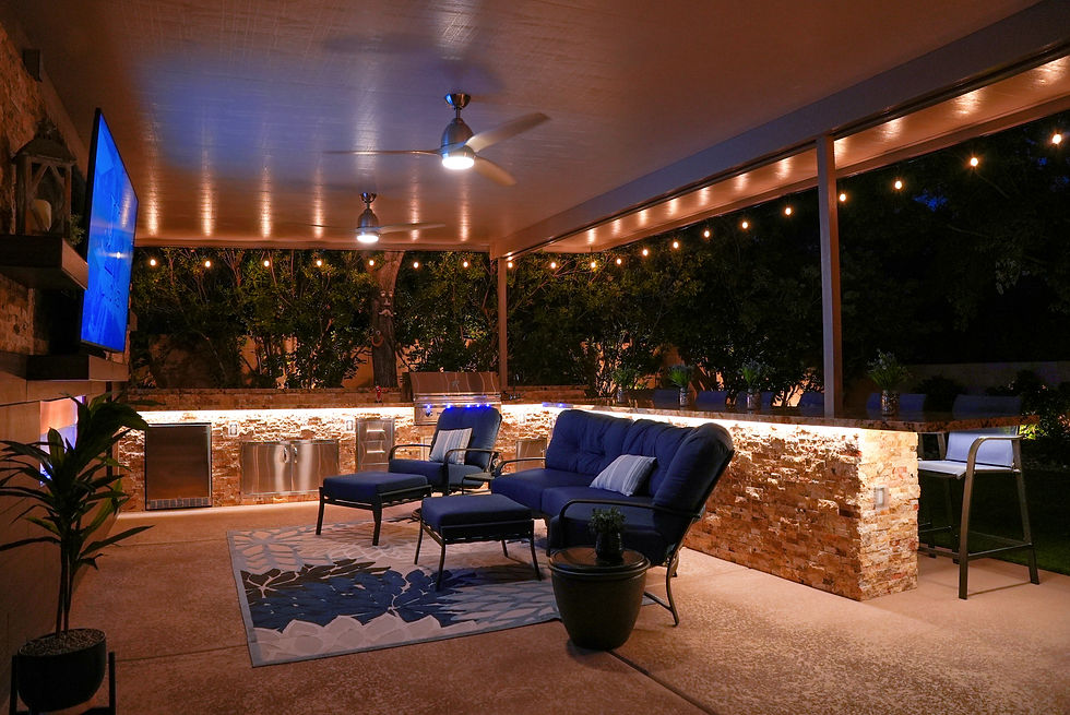 Patio with comfortable seating, ambient string lights, and a sleek built-in grill, perfect for evening relaxation and entertaining.