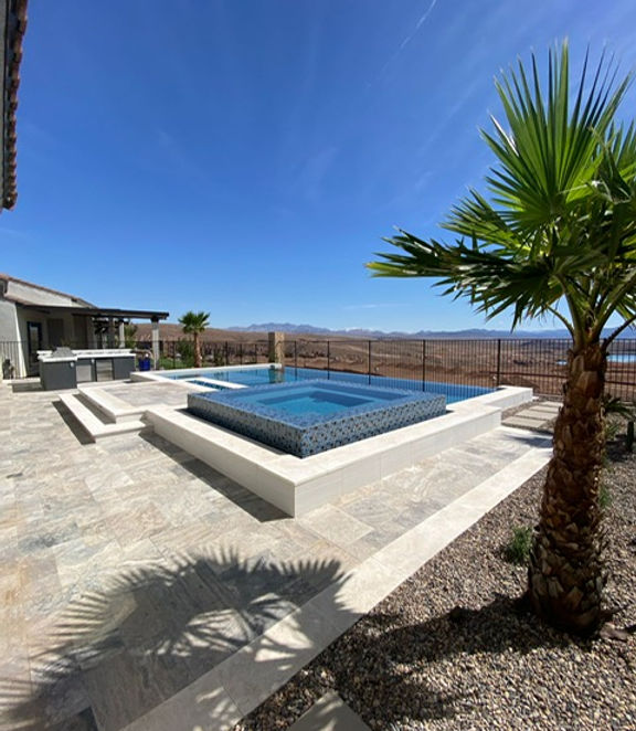 Modern elevated hot tub adjacent to the pool