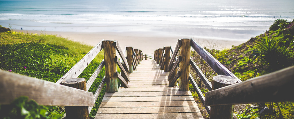 wooden steps down a dune to the beach