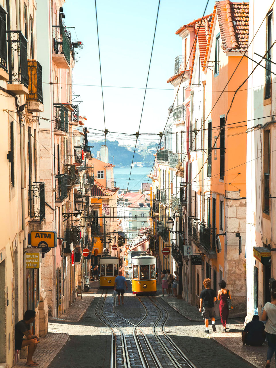 classic yellow street cars in a narrow Portuguese street