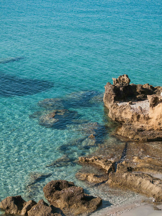 Rocky coastline with turquoise waters on Sardinia’s shore.