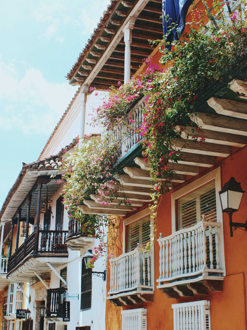 Balconies draped with flowers on a colonial street in Cartagena