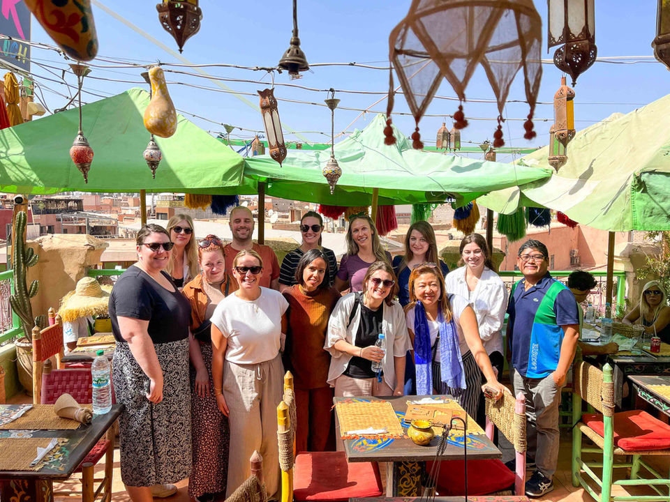 Young travelers gathered on a rooftop café on an FTLO Morocco trip