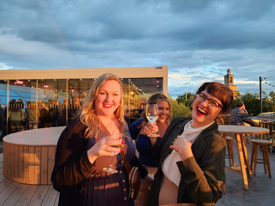 Friends enjoying rooftop drinks at golden hour in Copenhagen