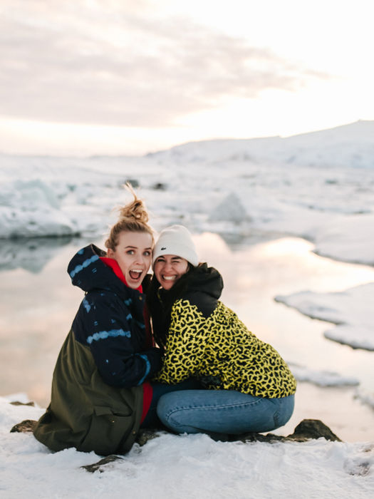 Two friends hugging on a snowy glacier during an Iceland FTLO trip