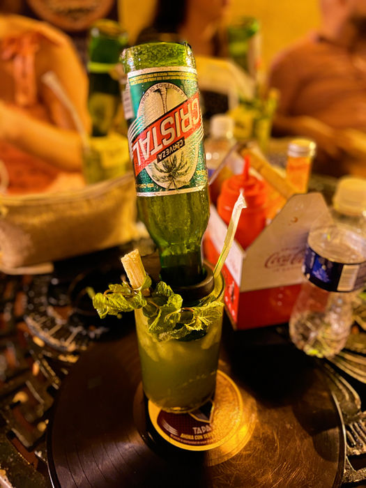 Mojito cocktail with Havana Club rum bottle served at a Havana bar