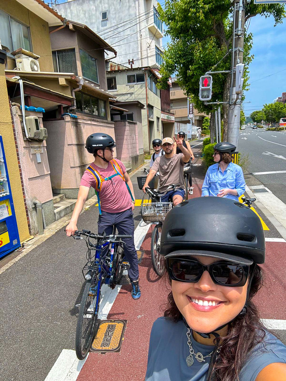 FTLO travelers biking through quiet streets in Japan during a group ride.