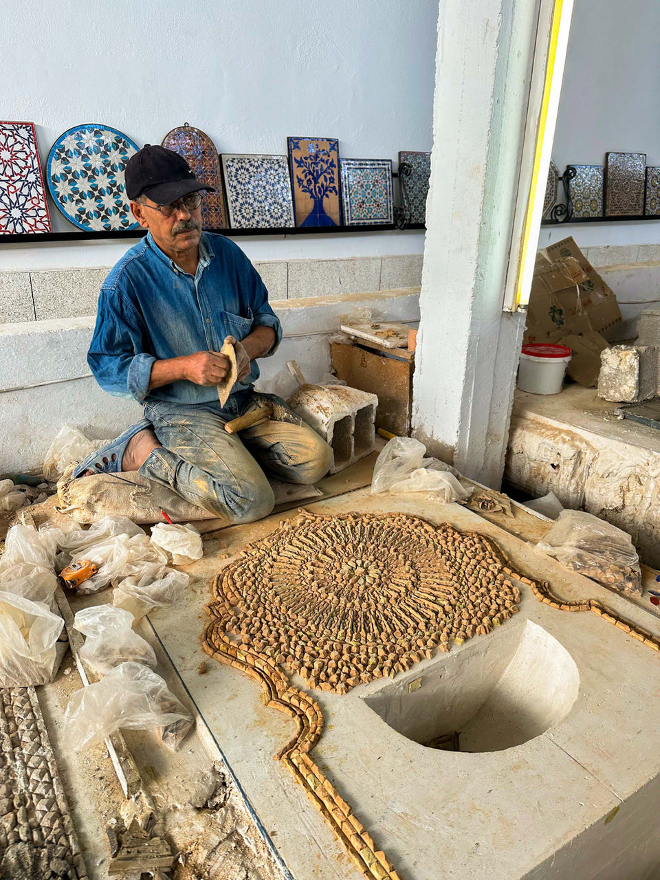 Local artisan baking traditional Moroccan bread in a clay oven