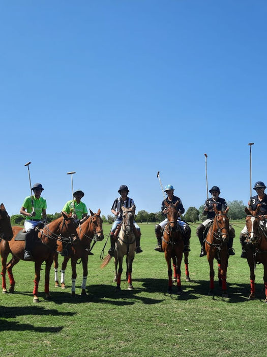 group of FTLO travelers on horses holding polo sticks in Argentina
