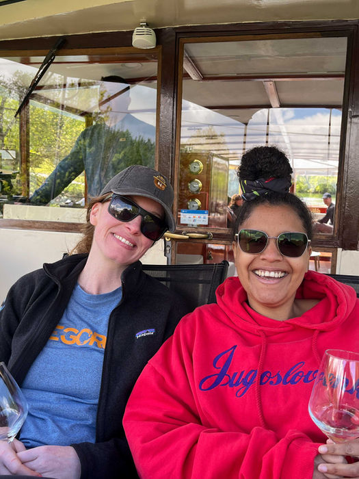 Friends relaxing with wine on a Lake Bled boat ride.