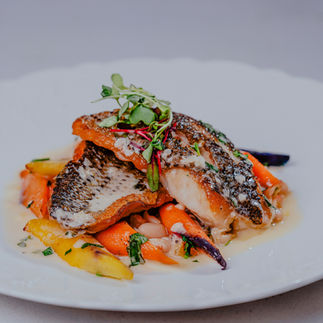 Roasted Wild Sea Bass with Citrus White Bean Mash, Caramelized Heirloom Baby Vegetables, & Herb Butter