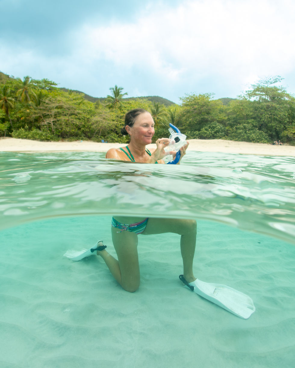 Snorkeler at Cinnamon Bay rubbing saliva inside her mask to stop it from fogging
