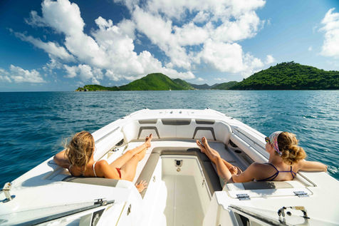 Guests relaxing on the bow of a private boat cruising through the Virgin Islands