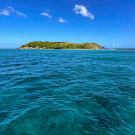 Moderate 10–15 knot winds creating small rolling waves in the USVI, typical conditions for a comfortable boat day