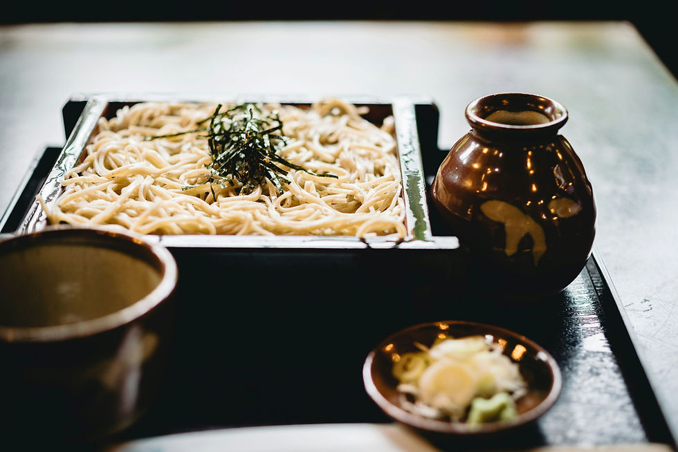 Soba (a square container holding soba noodles and surrounded by smaller containers) Reference: Photo by Masaaki Komori on Unsplash