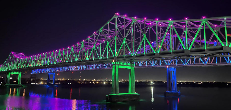 the New Orleans bridge at night from the water
