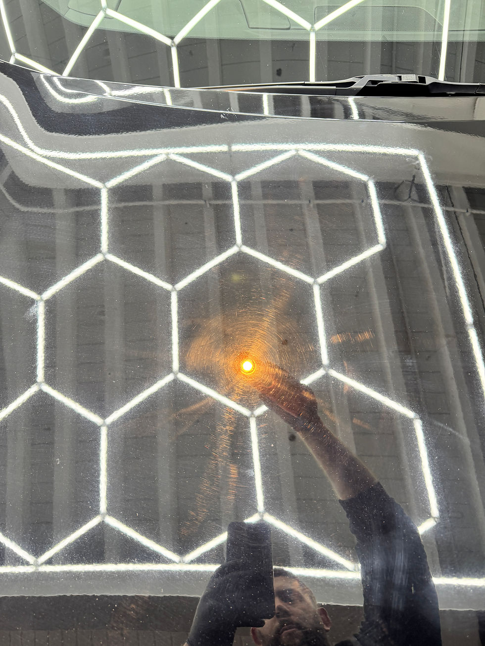Person welding a hexagonal metal grid structure