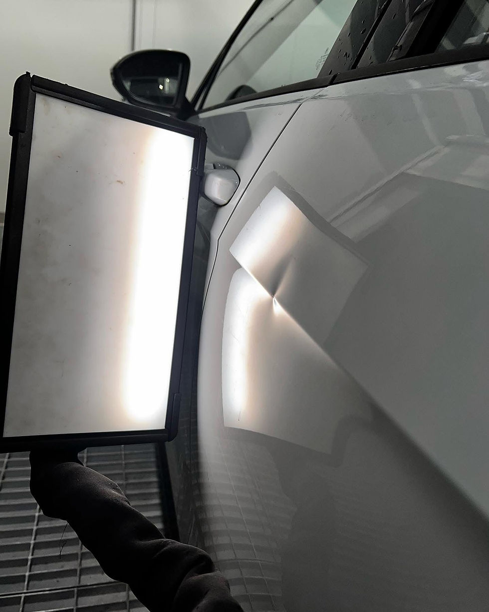 Car dent repair assessment using light