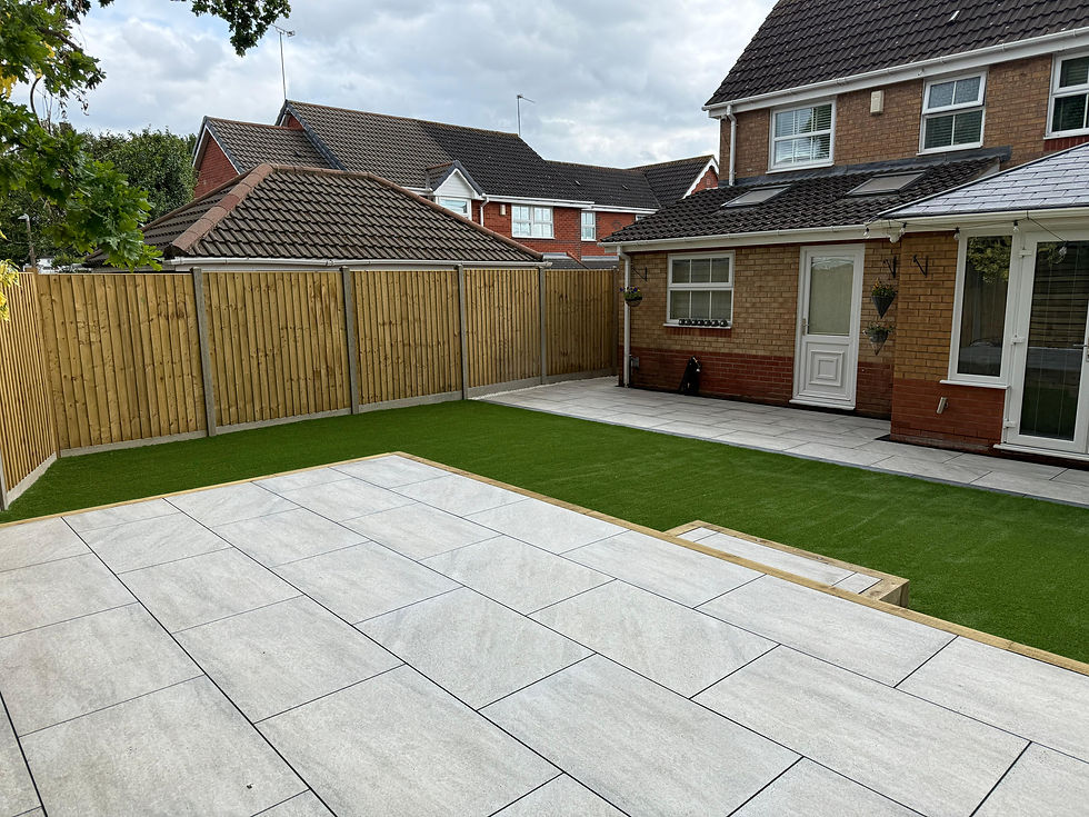 Patio with fresh green grass, fence. Kt-Landscaping in a backyard setting.