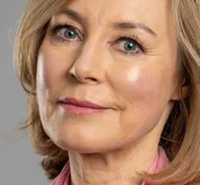 Sian Williams with short blonde hair and pink shirt smiles softly, set against a gray background. "The Psychologist" text appears at the top.