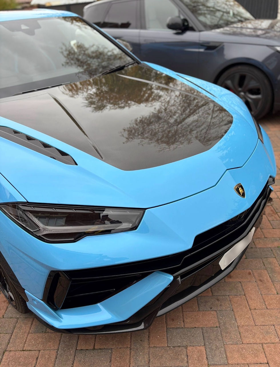 Front view of a light blue sports SUV with a dark hood