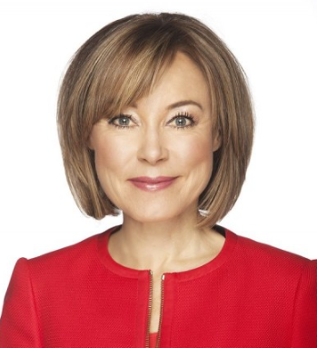 Sian Williams smiling woman with short brown hair wearing a red jacket in front of a plain white background.