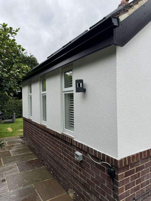 House exterior with black gutters and white render