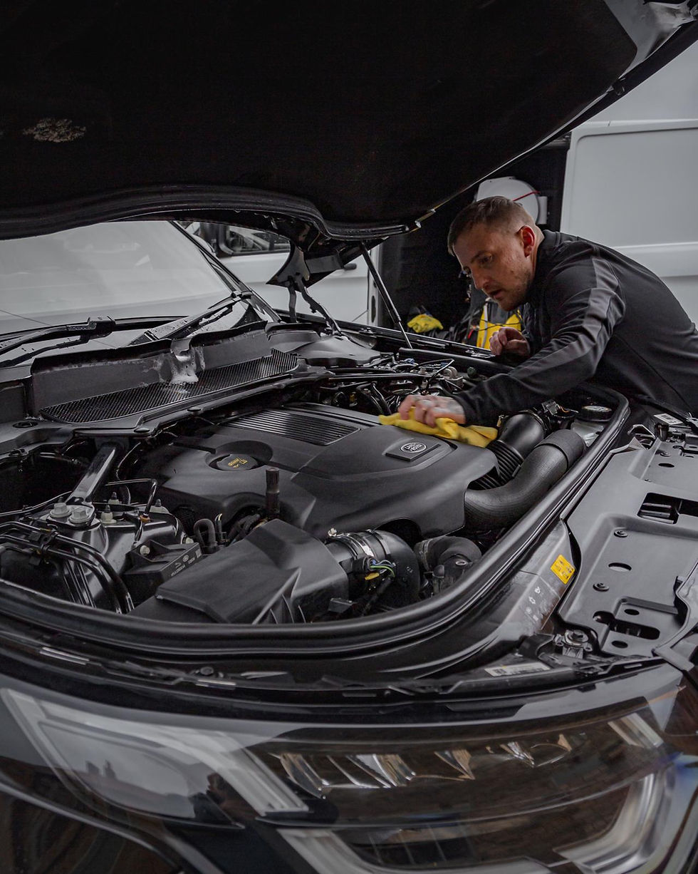 Mechanic cleaning car engine